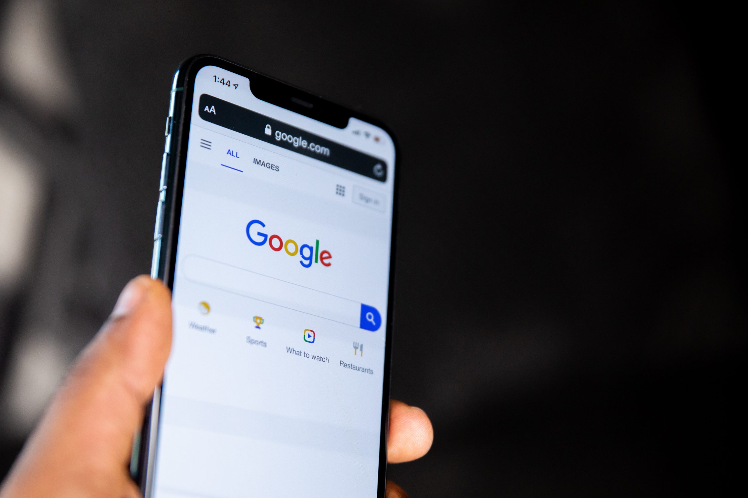 a-person-holding-a-black-android-smartphone A person holding a black android smartphone