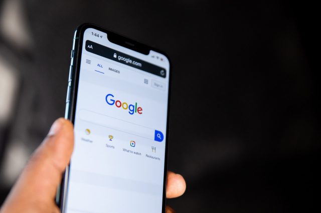 a-person-holding-a-black-android-smartphone A person holding a black android smartphone