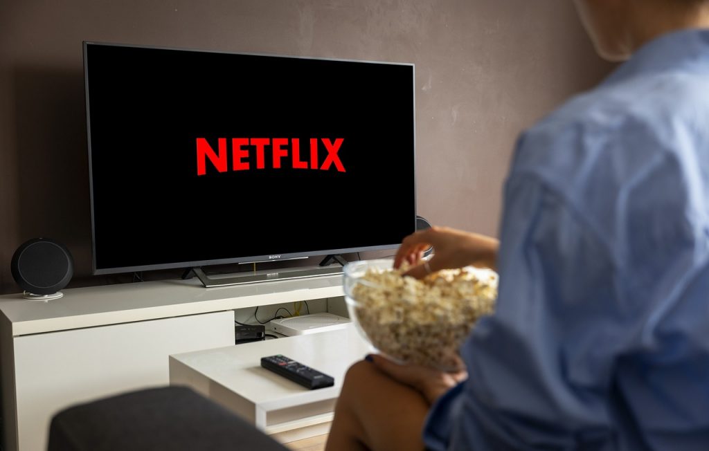 Man eating popcorn watching Netflix